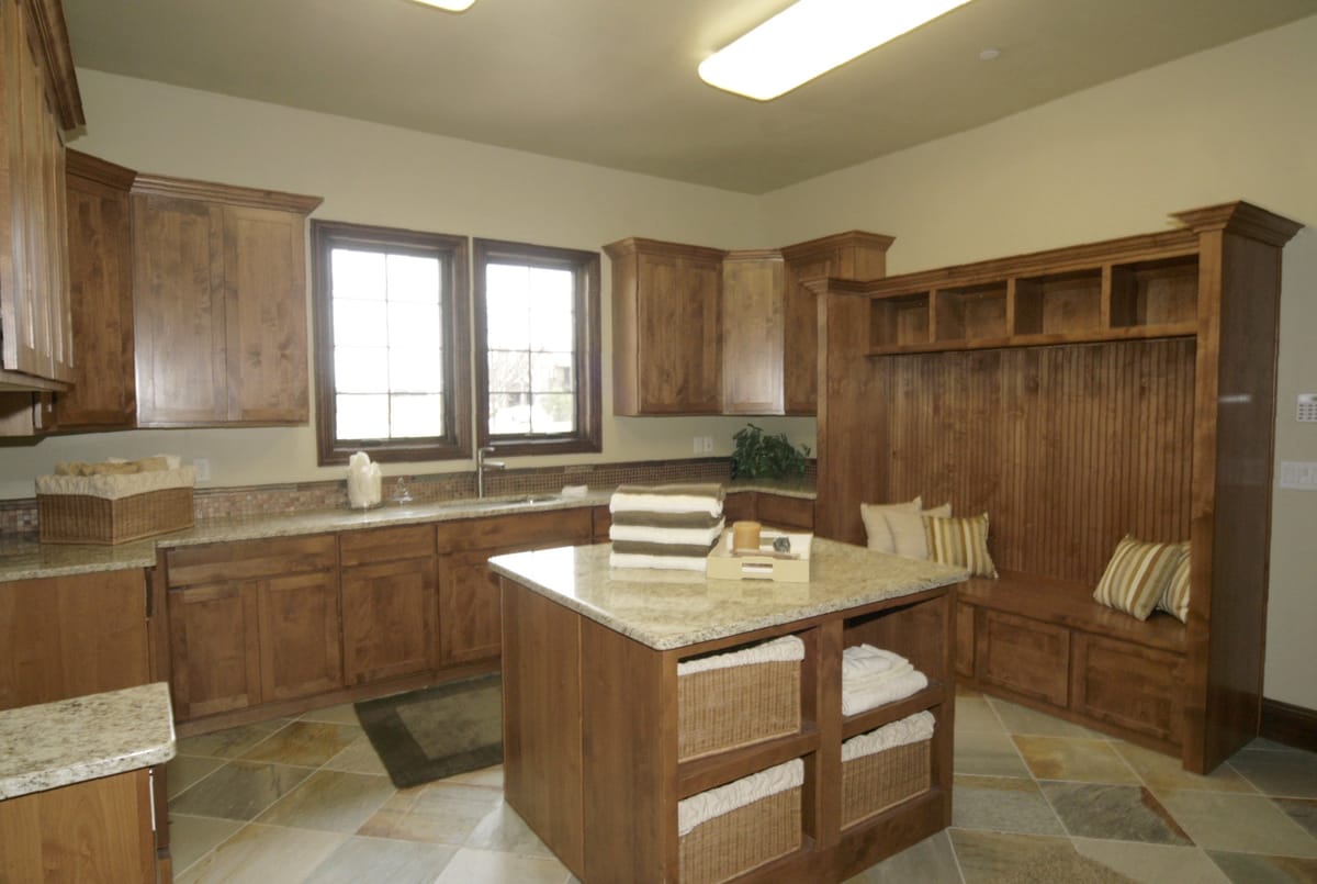 A laundry and mudroom with a folding counter and built-in lockers