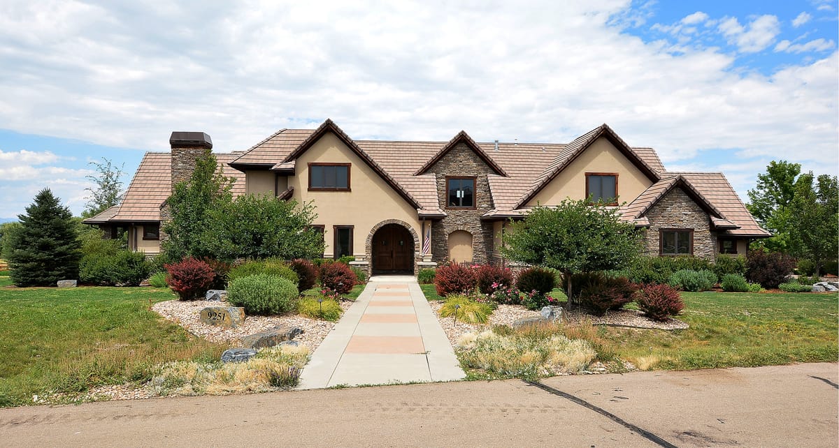 The home behind a stepped stone walk and clipped shrubs