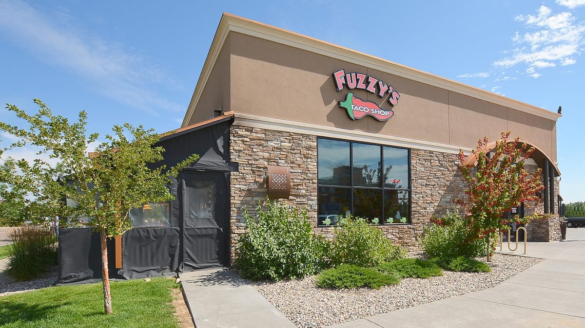 A restaurant with stone columns and a dark timber facade