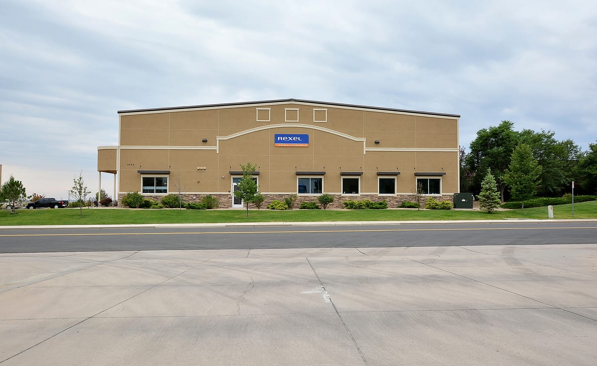 The warehouse office frontage with windows and landscaping