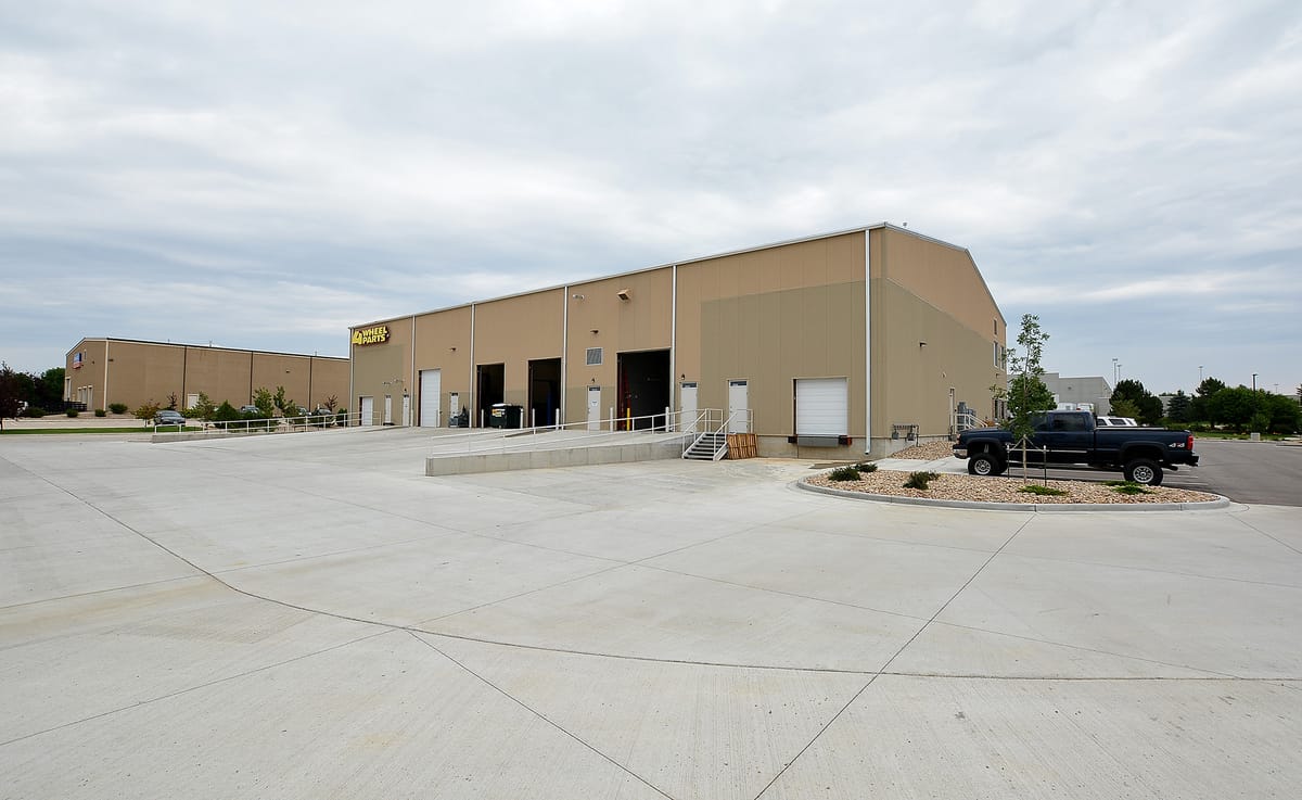 The warehouse seen across its concrete yard