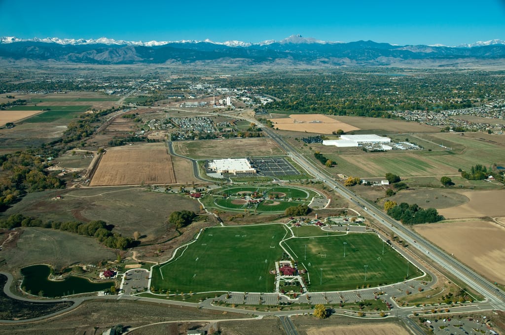 An aerial view of Longmont with the Front Range on the horizon
